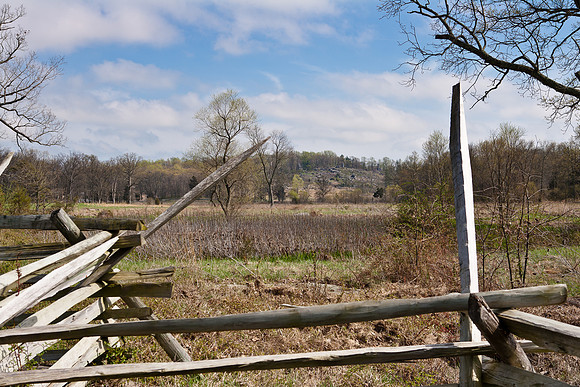 Little Round Top, framed by spear-shaped fence posts
